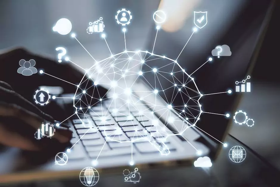 close up shot of hands using laptop and a hologram of a brain